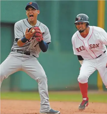  ?? STAFF PHOTO BY NANCY LANE ?? GOTCHA: Detroit shortstop Jose Iglesias reacts after tagging out Shane Victorino on the front end of a double play in the sixth inning of yesterday’s game.