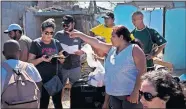  ?? [RAMON ESPINOSA/THE ASSOCIATED PRESS] ?? Volunteers distribute donations Wednesday to those affected by last week's tornado in El Roble, on the outskirts of Havana, Cuba.