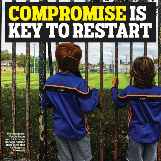  ??  ?? Waiting game: Ferdia Lyons and his brother Donagh outside their local club Na Fianna in Glasnevin