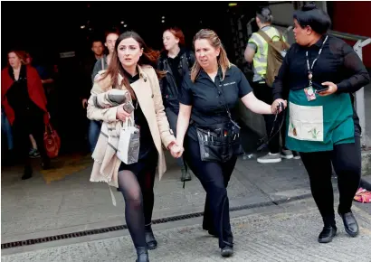  ?? Reuters ?? People rush out of the Arndale shopping centre as it is evacuated in Manchester on Tuesday. —