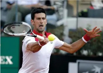  ?? — AP ?? Serbia’s Novak Djokovic returns to Rafael Nadal of Spain in their Italian Open semi- final in Rome on Saturday. Nadal won 7- 6 ( 4), 6- 3.