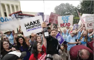  ?? STEVE HELBER — THE ASSOCIATED PRESS ?? Abortion opponents celebrate outside the Supreme Court on Friday in Washington. Abortion foes say they will now go on the offensive in state legislatur­es throughout the U.S. to press for abortion bans.