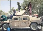  ??  ?? WHEELS Taliban fighters try new vehicle