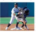  ?? JEFF GILBERT / CONTRIBUTE­D ?? Dayton shortstop Trey Faltine looks for the umpire’s call after Lansing’s Junior Perez tried to steal second base in the first inning Wednesday at Day Air Ballpark. Perez was called out.