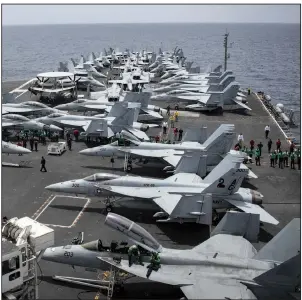  ?? AP/U.S. Navy/MASS COMMUNICAT­ION SPECIALIST 3RD CLASS GARRETT LaBARGE ?? Sailors search for foreign objects and debris on the flight deck of the Nimitz-class aircraft carrier USS Abraham Lincoln in the Arabian Sea on Sunday.