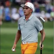  ?? CHRIS O’MEARA — THE ASSOCIATED PRESS ?? Rickie Fowler finishes the 16th hole during the final round of the PGA Championsh­ip golf tournament at the Quail Hollow Club Sunday in Charlotte, N.C.