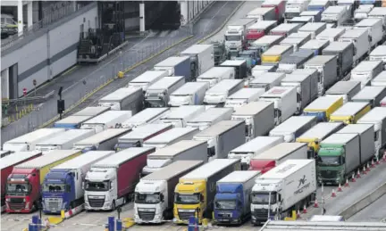  ??  ?? DOVER, England — Freight lorries are seen queueing as they wait to enter the port of Dover on the south coast of England on December 10, 2020 before boarding a ferry to Europe. Big queues of lorries snaked into the port for another day with high volumes of freight traffic and disruption at other cargo ports attributed to Brexit stockpilin­g, pre-christmas build-up, and transport of medical supplies for COVID care increasing demand.