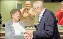  ?? Jeremy Stewart ?? Cathy Matthews (left) is congratula­ted by Polk County Commission Chairman Hal Floyd for being named the county’s Citizen of the Year at the board’s December 2022 work session.