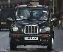  ?? AFP ?? A LONDON black taxicab is driven along a street in central London on March 22, 2017.