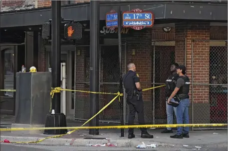  ?? CHRIS O’MEARA — THE ASSOCIATED PRESS ?? Tampa police officers stand in the street in the Ybor City section of Tampa, Fla., after a shooting Sunday. A fight between two groups turned deadly in a shooting during Halloween festivitie­s.