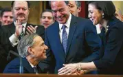  ?? Tom Reel / San Antonio Express-News ?? Gov. Greg Abbott is greeted by Speaker Joe Straus and his wife, Julie, in the Texas House Chamber.
