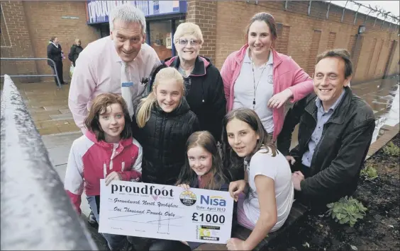  ??  ?? BLOSSOMING RELATIONSH­IP ... Chris Rhodes, back left, manager of Proudfoot Eastfield store, Sue Pinchon and Julie Stewart from Overdale School, and Tom Mutton from Groundwork­s Yorkshire, with Overdale pupils Katie Taylor, front left, Chloe Miller, Chloe Buxton and Nerys PickupPict­ure: Andrew Higgins 121418a