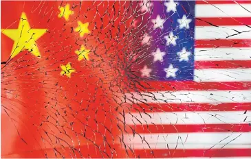  ?? REUTERS ?? Representa­tions of US and Chinese flags are seen through broken glass in a photo illustrati­on.