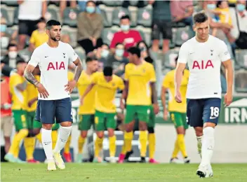  ??  ?? Downbeat: Cristian Romero (left) and Giovani Lo Celso are dejected after Tottenham concede