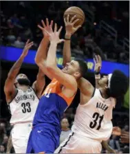  ?? TONY DEJAK — THE ASSOCIATED PRESS ?? The Nets’ Allen Crabbe (33), Jarrett Allen and the Cavaliers’ Ante Zizic vie for the ball on Feb. 13 at The Q.