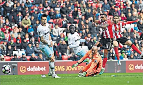  ??  ?? In the nick of time: Fabio Borini (far right) pounces to score Sunderland’s equaliser in the last minute as the Premier League strugglers finally earn some respite