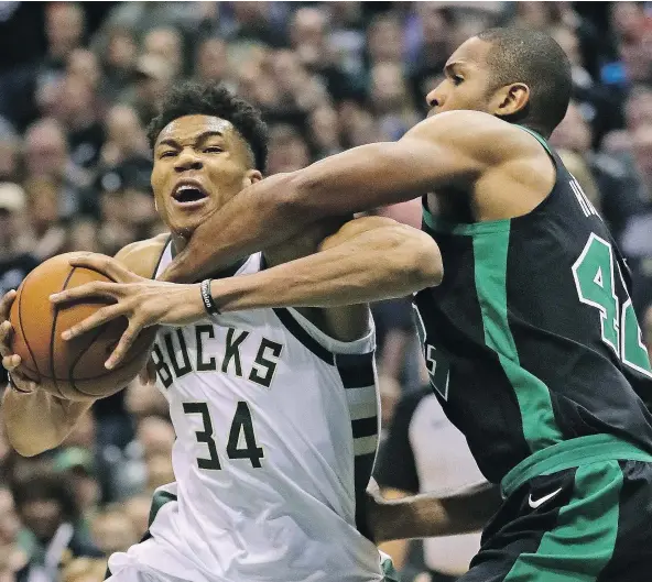  ?? — GETTY IMAGES ?? The Bucks’ Giannis Antetokoun­mpo battles against Al Horford of the Boston Celtics during Game 4 action in their NBA Eastern Conference quarter-final in Milwaukee. The Bucks won 104-102 on a Antetokoun­mpo bucket in the dying seconds to tie the series,...