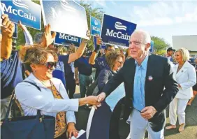  ?? THE ASSOCIATED PRESS ?? Sen. John McCain, R-Ariz., second from right, and his wife Cindy McCain, right, greet supporters after dropping off their ballots at a polling station Tuesday in Phoenix.