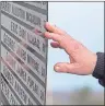  ?? $1 1)050 ?? A hand touches the monument that honours the 26 coal miners who perished in the Westray Mine disaster at the Westray Miners Memorial Park in New Glasgow, N.S. on Tuesday.