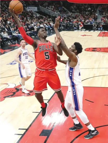  ?? | CHARLES REX ARBOGAST/ AP ?? Bobby Portis ( shooting over Joel Embiid) scored a career- high 38 points Thursday against the Sixers.