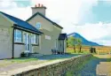  ??  ?? Cashelnago­r, Donegal's remotest station, pictured with Mount Errigal ahead, as would have been seen from L&BER trains. HUGH DOUGHERTY