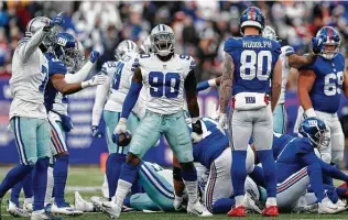  ?? Steve Luciano / Associated Press ?? Defensive end DeMarcus Lawrence (90) is among the star players the Cowboys are considerin­g releasing to save salary cap dollars in hopes of helping to benefit the franchise in the future.