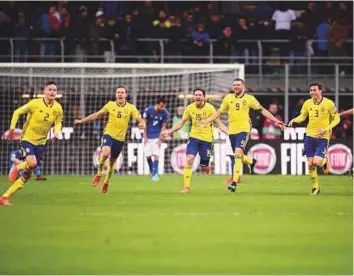  ?? AFP ?? From left: Sweden’s Mikael Lustig, Ludwig Augustinss­on, Gustav Svensson, Marcus Berg and Victor Lindeloef celebrate after the win over Italy on Monday.