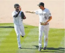  ??  ?? Rockies shortstop Jose Reyes and second baseman DJ LeMahieu celebrate a triple play in Game 1. Doug Pensinger, Getty Images