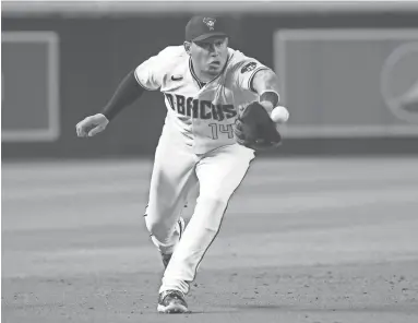  ??  ?? Arizona Diamondbac­ks third baseman Asdrubal Cabrera fields a ground ball hit by the Oakland Athletics’ Mark Canha during the ninth inning at Chase Field in Phoenix on Tuesday.