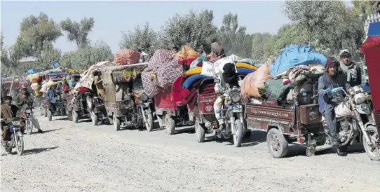  ?? (Photo: AP) ?? Afghan families leave their houses after fighting between the Afghan military and Taliban insurgents in Helmand province, southern Afghanista­n, Tuesday, October 13, 2020.