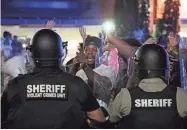  ?? TRACY KIMBALL/THE CHARLOTTE OBSERVER VIA AP, FILE ?? A protester confronts police officers in riot gear on June 24, 2021, in downtown Rock Hill.