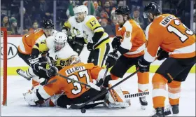  ?? MATT SLOCUM — THE ASSOCIATED PRESS ?? Pittsburgh’s Sidney Crosby (87) tries to get a shot past Flyers goalie Brian Elliott (37) as Philippe Myers (5), Ivan Provorov (9) and Kevin Hayes (13) defend during the third period.