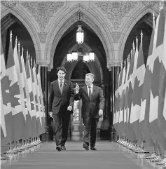  ??  ?? Trudeau (left) and Santos walk in the Hall of Honour on Parliament Hill in Ottawa, Ontario, Canada. — Reuters photo