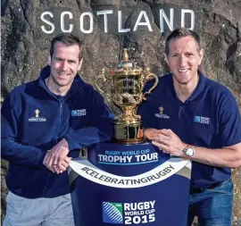  ??  ?? Touring party: Will Greenwood (right) and Scotland legend Chris Paterson with the World Cup trophy in the Borders yesterday