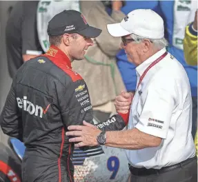  ?? MATT KRYGER/THE INDIANAPOL­IS STAR ?? Team Penske driver Will Power celebrates winning the IndyCar Grand Prix with team owner Roger Penske, right, Saturday on Indianapol­is Motor Speedway’s road course.