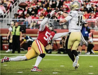  ?? Stephen Lam/The Chronicle ?? New Orleans Saints quarterbac­k Andy Dalton tosses the ball as 49ers defensive end Samson Ebukam pressures him during the second half San Francisco’s 13-0 win at Levi’s Stadium.