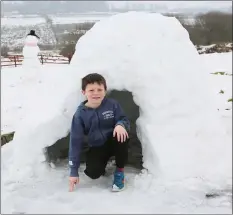  ??  ?? Eoghan O’Riordan from Ballydesmo­nd constructe­d this icy igloo during ‘snow day’ on Friday.