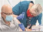  ?? GREG LOVETT/ USA TODAY NETWORK ?? Richard Herman, 82, receives the Moderna vaccine from nurse Sherry Phillips on Dec. 30 in Delray Beach, Fla.