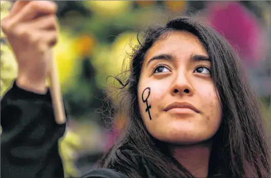  ?? AP PHOTO ?? A woman waves a flag during a protest marking the Internatio­nal Women’s Day in Madrid, Thursday.