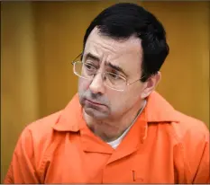  ??  ?? In this Feb. 2 file photo, Larry Nassar listens as Melissa Alexander Vigogne gives her victim statement in Eaton County Circuit Court in Charlotte, Mich. mATThEw DAE smITh/lAnsInG sTATE JournAl VIA AP