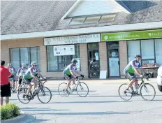  ?? ALLAN BENNER/STANDARD STAFF ?? Larry Boggio, right, leads the way as participan­ts of the Wellspring Niagara Tour du Lac leave for a six-day ride around Lake Ontario on Sunday.