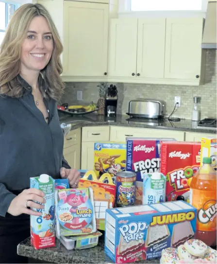  ?? THE CANADIAN PRESS/HEART AND STROKE FOUNDATION ?? University of Ottawa researcher Monique Potvin Kent poses with a selection of food and beverage products marketed to kids on popular websites in this undated handout photo.