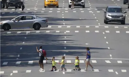  ?? Photograph: John Angelillo/UPI/REX/Shuttersto­ck ?? Schoolchil­dren crossing 10th Avenue