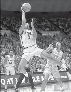  ?? Bill Feig Associated Press ?? JAVONTE SMART of Louisiana State shoots in front of Jordan Bowden of Tennessee in the first half. Smart had 29 points in the Tigers’ 82-80 overtime victory.
