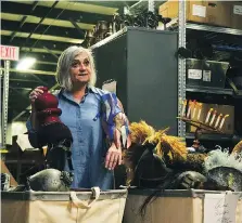  ?? GALEN SIMMONS ?? Dona Hrabluk, the Stratford Festival’s head of props, sorts through some of the items that will be available at this weekend’s festival warehouse sale.