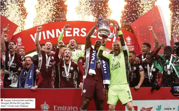  ??  ?? ■ Kasper Schmeichel and Wes Morgan lift the FA Cup after their 1-0 win over Chelsea