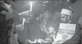  ?? EMRAH GUREL/AP ?? Activists hold a vigil for the slain journalist outside the Saudi consulate in Istanbul.