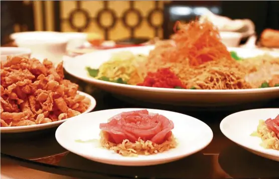  ??  ?? Li Yen’s Dinner Set B starts with tuna yee sang (left), which is followed by double-boiled chicken soup with fish maw, dried scallops and conch (right). — Photos: CHAN TAK KONG/ The Star