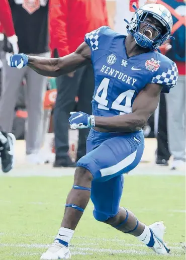  ?? SAMGREENWO­OD/GETTY ?? Kentucky’s Jamin Davis celebrates a defensive stop against North Carolina State during the TaxSlayer Gator Bowl on Saturday at TIAA Bank Field in Jacksonvil­le, Fla.