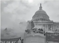  ?? KENNY HOLSTON/THE NEW YORK TIMES ?? Supporters of President Donald Trump storm the U.S. Capitol in Washington on Wednesday.